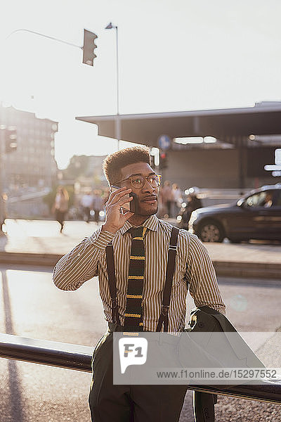 Businessman using smartphone on pavement  Milano  Lombardia  Italy