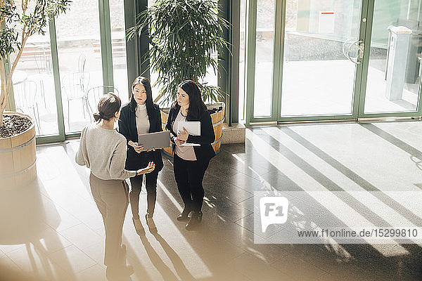 High angle view of multi-ethnic businesswomen discussing during conference at office