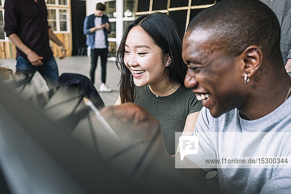 Cheerful multi-ethnic IT professionals planning at creative office