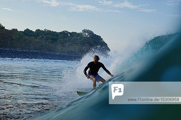 Male surfer riding ocean wave