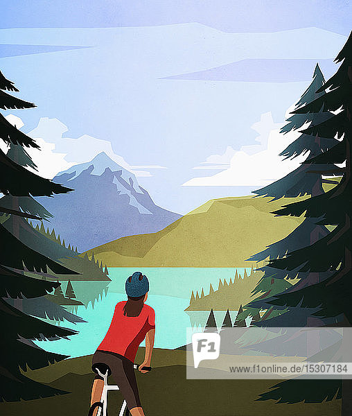Mountainbikerin mit Blick auf einen idyllischen  ruhigen Bergsee