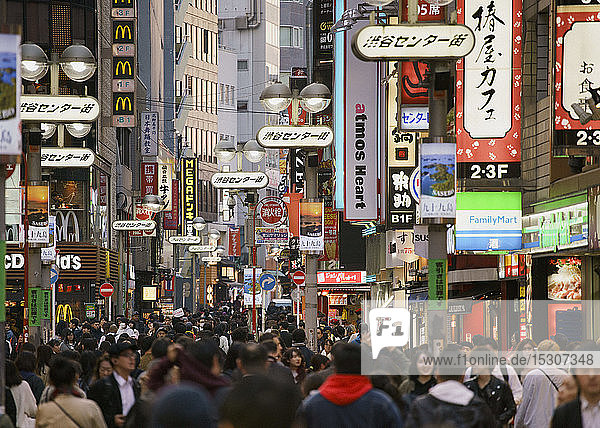 Pedestrians on bustling modern city street  Shibuya  Tokyo  Japan