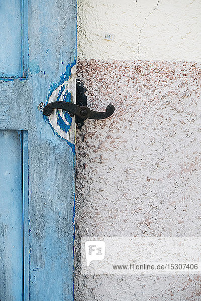 Iron latch on blue wooden door