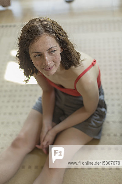 Woman relaxing  sitting on rug