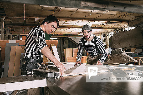 Carpenters at work on a saw