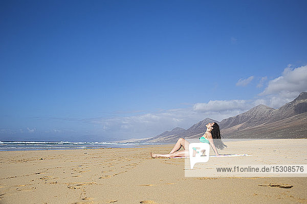 Woman taking sunbath on the beach  Fuerteventura  Spain