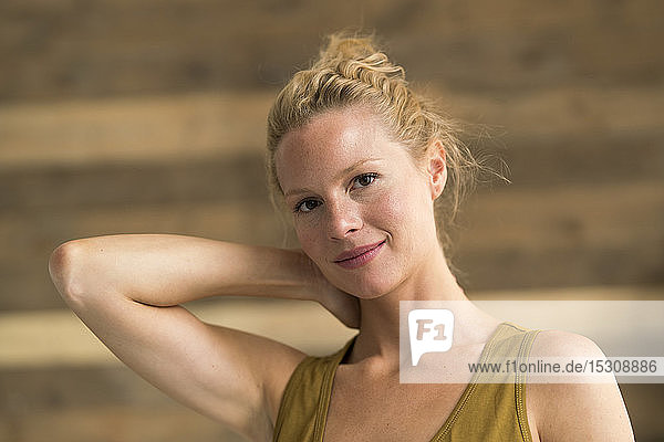 Portrait of beautiful blond woman  wooden background