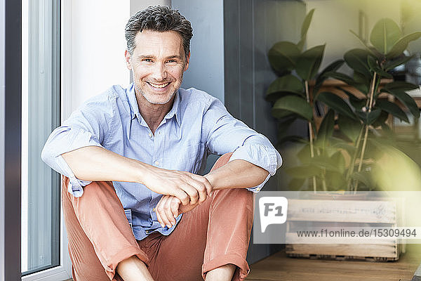 Mature man relaxing at home smiling