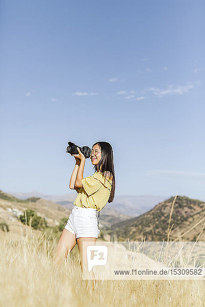 Young woman taking pictures in remote landscape  Granada  Spain