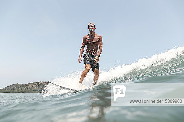 Surfer with action camera in the mouth