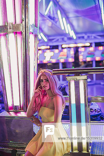 Portrait of a young woman on a funfair at night