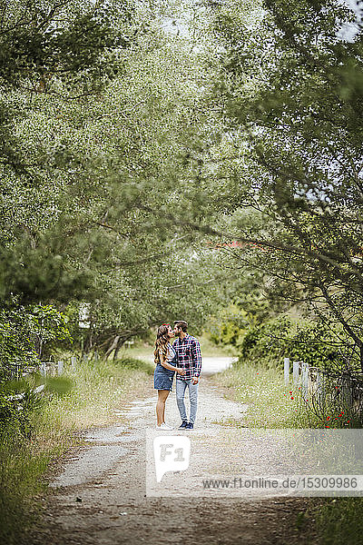 Young couple kissing on a path