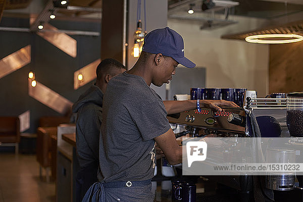 Young man preparing coffee at the coffee shop