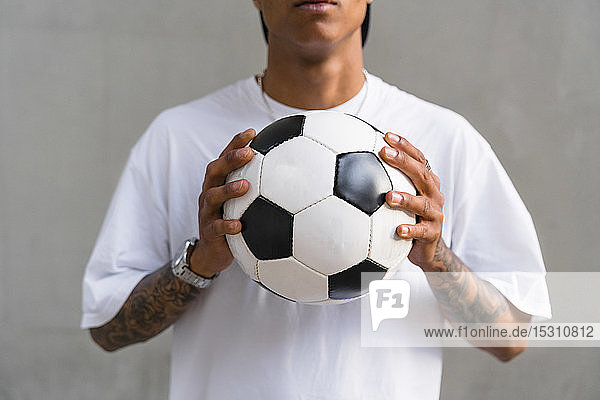 Young man's hands holding football  close-up