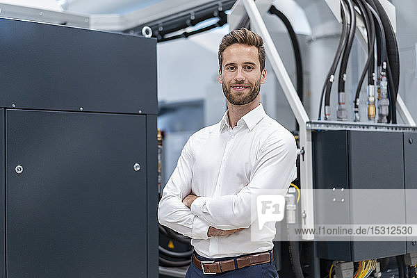 Portrait of a confident businessman in a modern factory