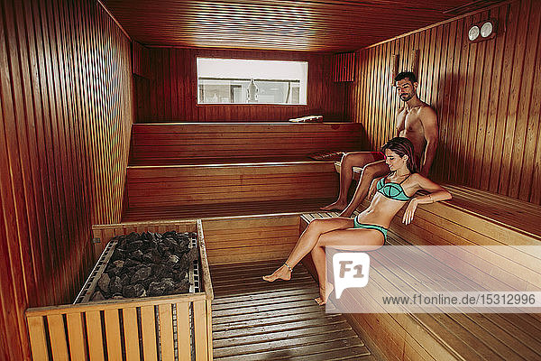 Couple relaxing in a sauna
