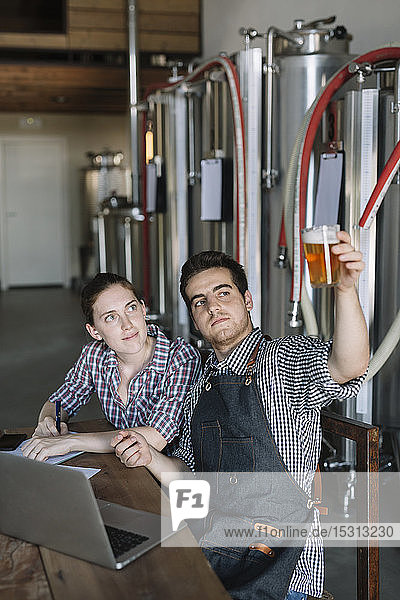 Jungunternehmer  die in einer Brauerei arbeiten und Bier testen