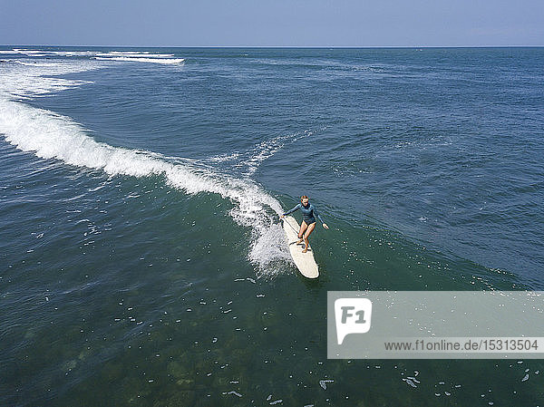 Aerial view of female surfer  Bali  Indonesia