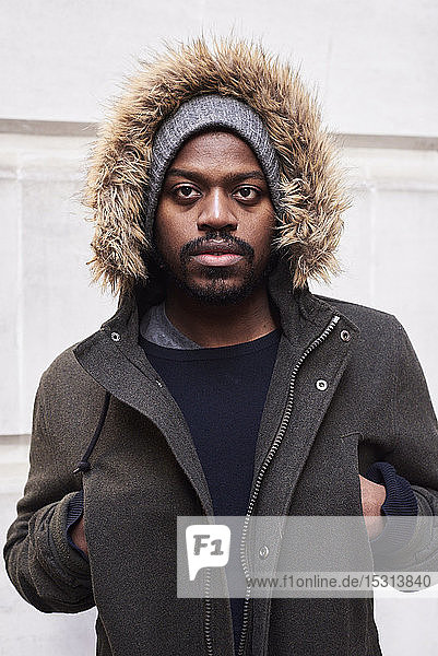 Portrait of mid adult man with hoodie in winter