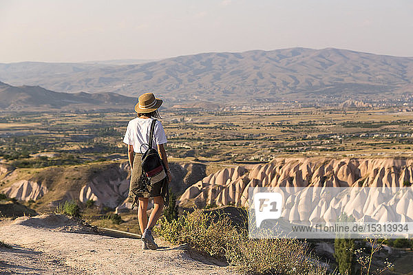 Woman walking to viewpoint near Uchisar  Cappadocia  Turkey