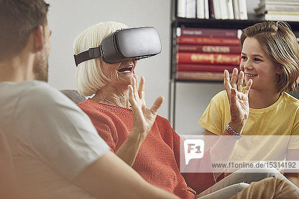 Grandmother using VR glasses with her grandsons