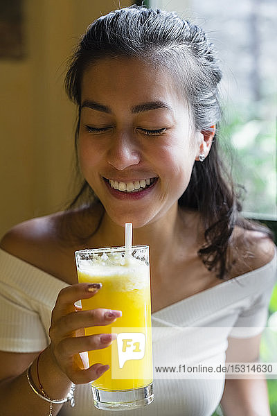 Young woman enjoying a smoothie