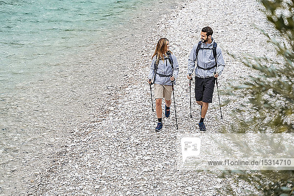 Young couple on a hiking trip walking at the riverside  Vorderriss  Bavaria  Germany