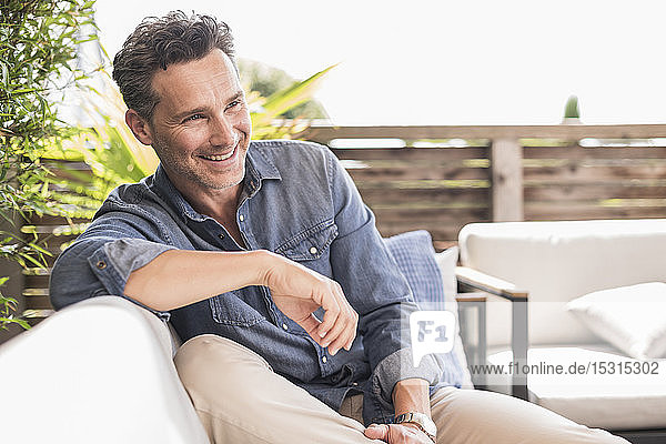 Confident man relaxing on the terrace