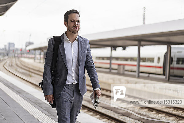 Businessman walking on station platform