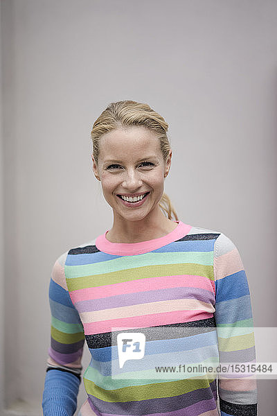 Portrait of beautiful blond woman  wearing striped pullover