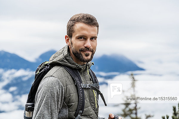 Porträt eines selbstbewussten jungen Mannes auf einer Wanderung in den Bergen  Herzogstand  Bayern  Deutschland