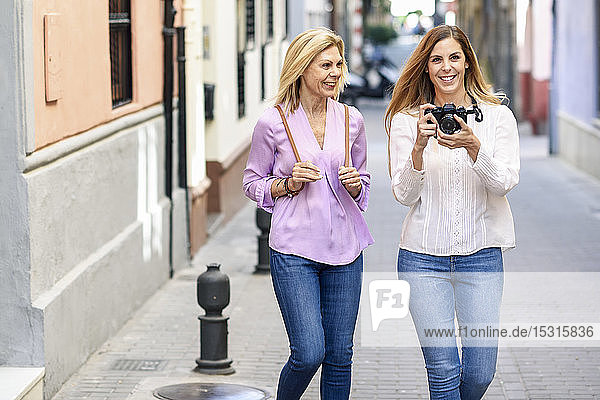 Mature woman traveling together with her daughter in the city