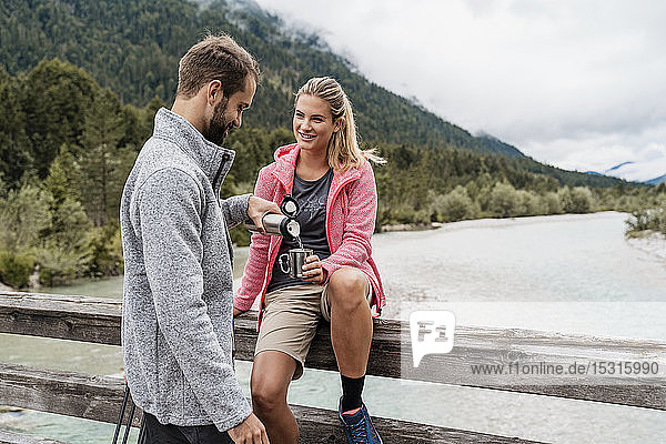 Young couple having a break during a hiking trip  Vorderriss  Bavaria  Germany