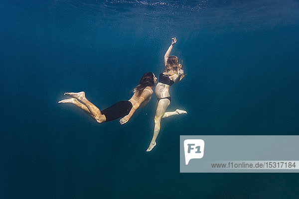 Young couple under water  woman pregnant