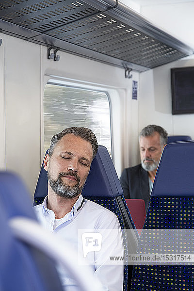 Mature man sitting in a train  sleeping