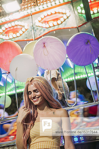 Happy young woman on a funfair at night