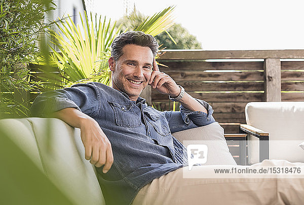 Confident man relaxing on the terrace