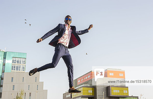 Young businessman jumping mid-air