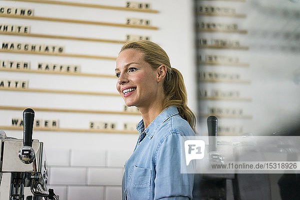 Blond woman working at the counter of a coffee shop