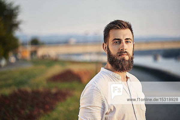 Portrait of a man with beard at a riveriside