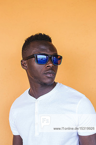 Portrait of young man wearing white t-shirt and sunglasses