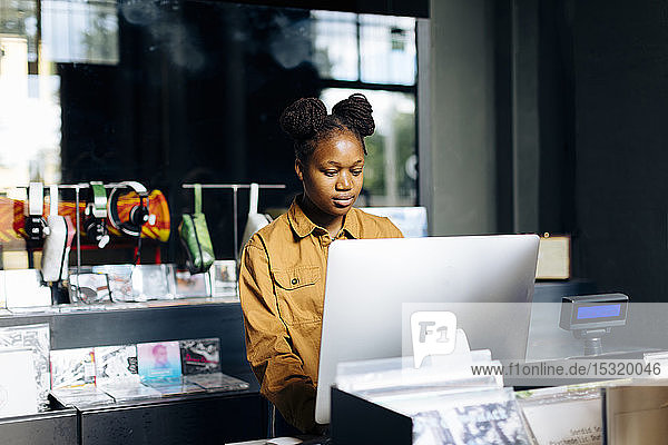 Young woman working in record store