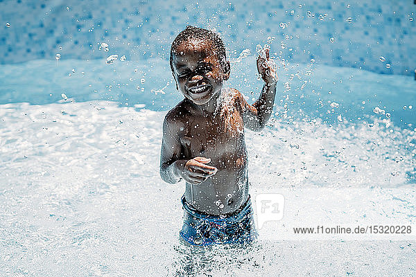 Happy little boy in swimming pool