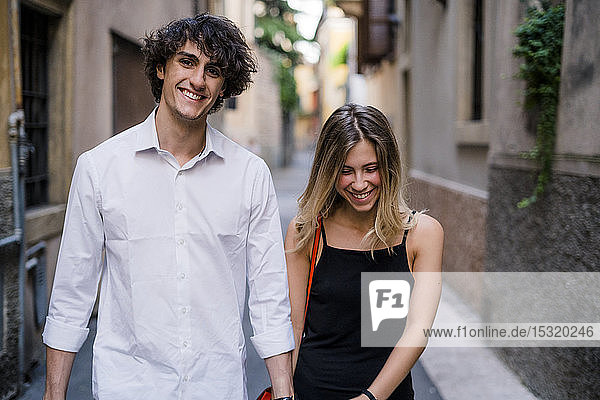 Happy young couple walking in the city