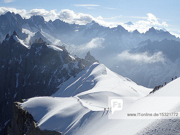 France  haute savoy  Chamonix  Mont blanc range  a group of alpinists is hiking on the snow edge of the aiguille du midi