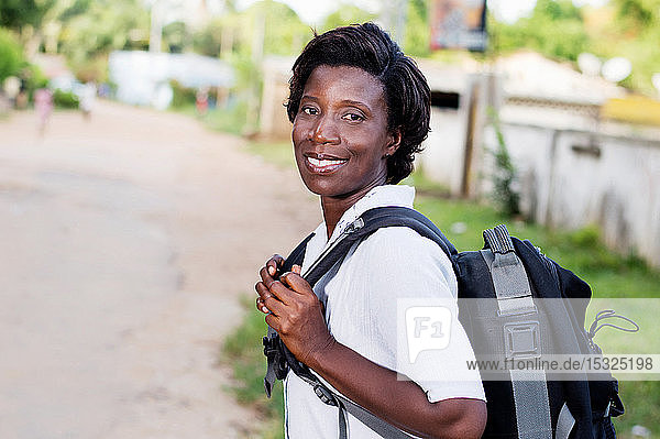 Travel  tourism - smiling young woman with backpack ready to hit the road.