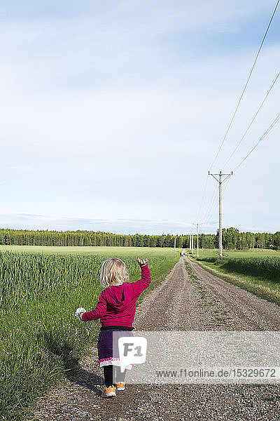 Girl walking on dirt road