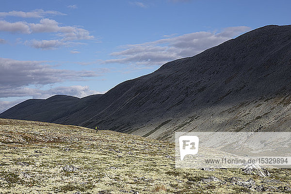 Man standing by hill in Rondane National Park Norway