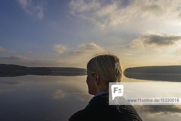 Mid adult woman in front of Lake Aspen in Lerum Sweden