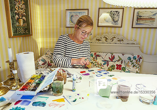 Woman painting with watercolors